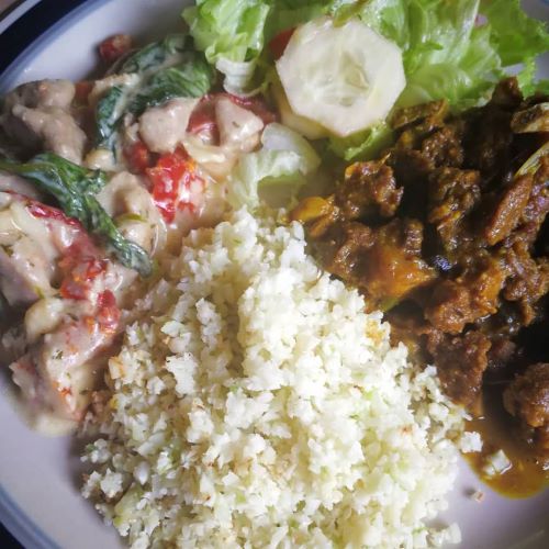 Cauliflower rice, creamy-cheesy chicken and curried goat