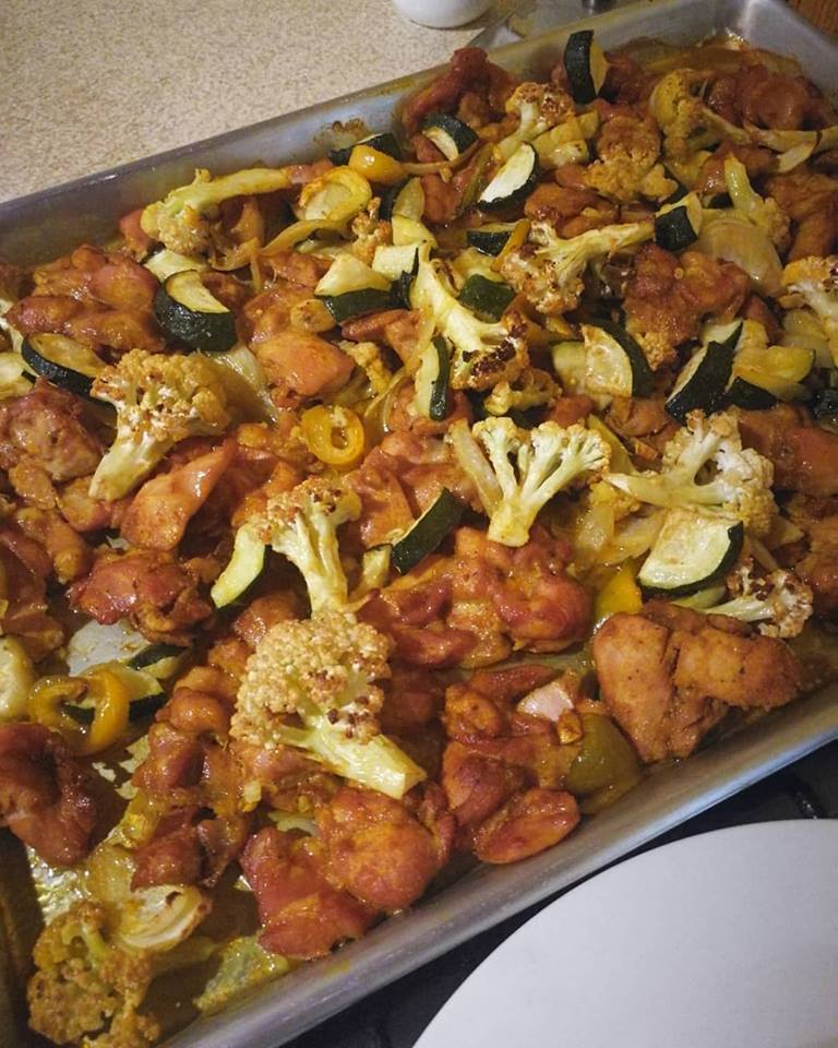 Boneless chicken thighs and veggies sheet pan meal done in the oven