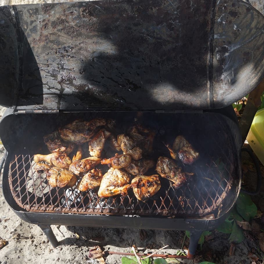 Chicken being grilled on the beach