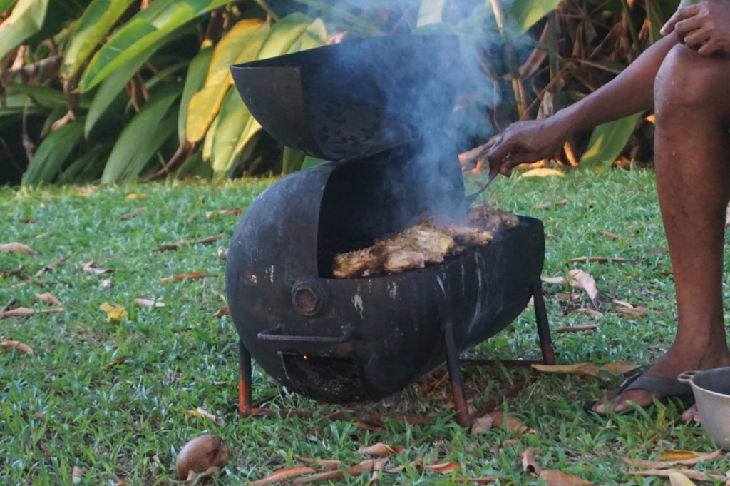 Grilling chicken under the mango tree at Goblin Hill